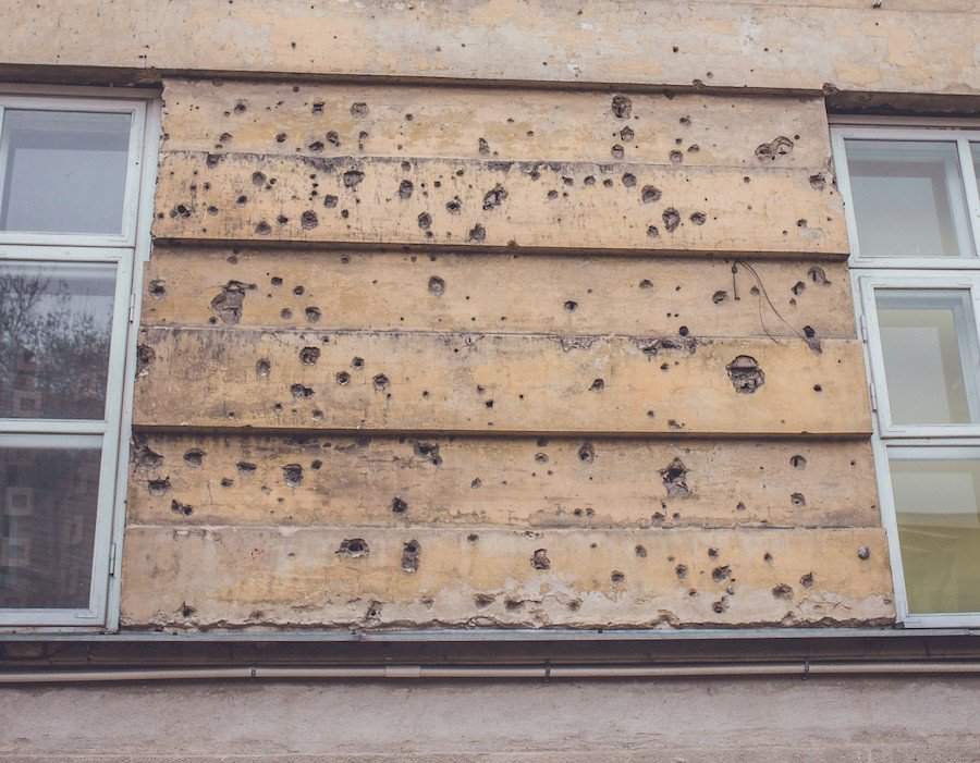 Bullet marks on the wall of the house